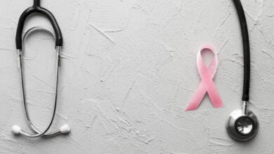 pink ribbon and black stethoscope on plaster