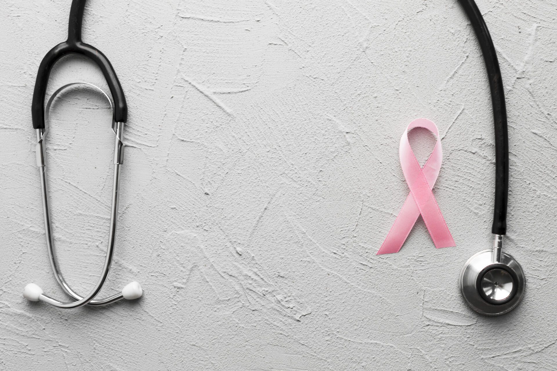 pink ribbon and black stethoscope on plaster