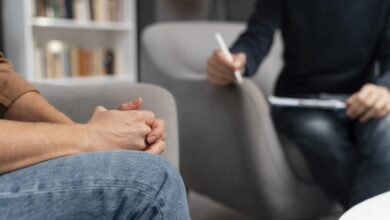 woman with hands together talking with counselor