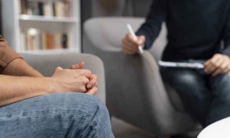 woman with hands together talking with counselor