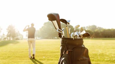 back view of male golfer swinging golf club